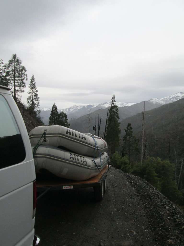 Nice view of vehicle with raft trailer driving on the Illinois River Road for a whitewater Rafting Trip