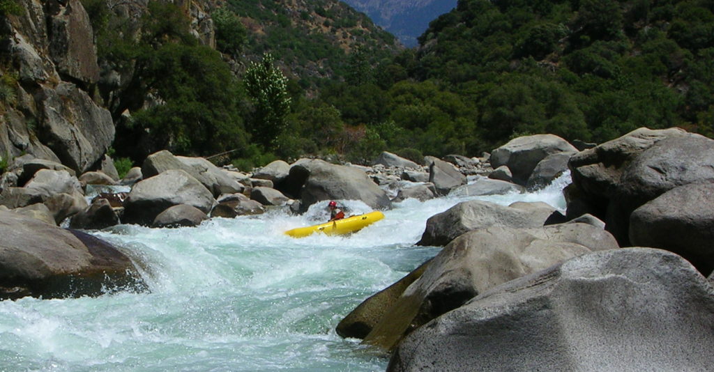 raft running whitewater rapid on an Upper Kings River Garlic Falls rafting and kayaking trip