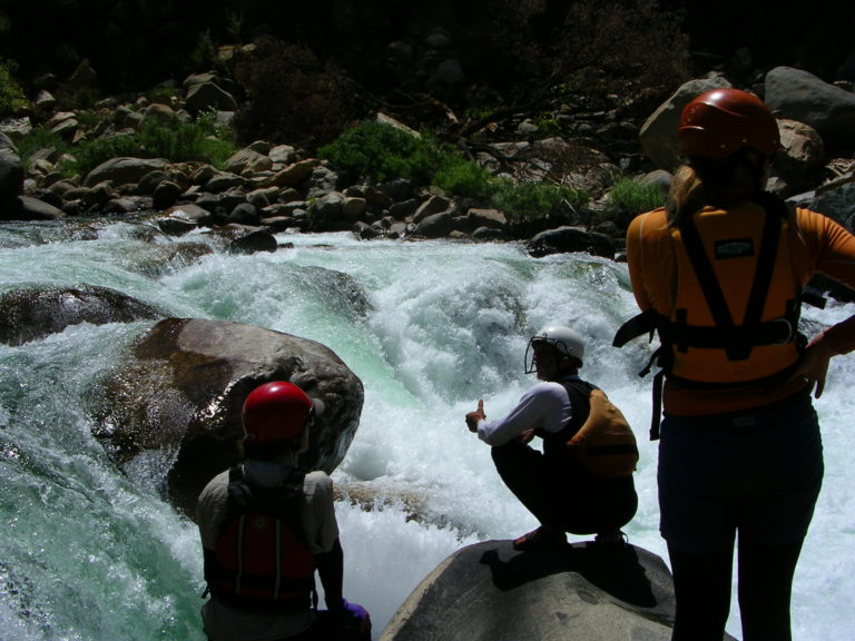paddlers scouting Cassidy Falls whitewater rapid on an Upper Kings River Garlic Falls rafting and kayaking trip