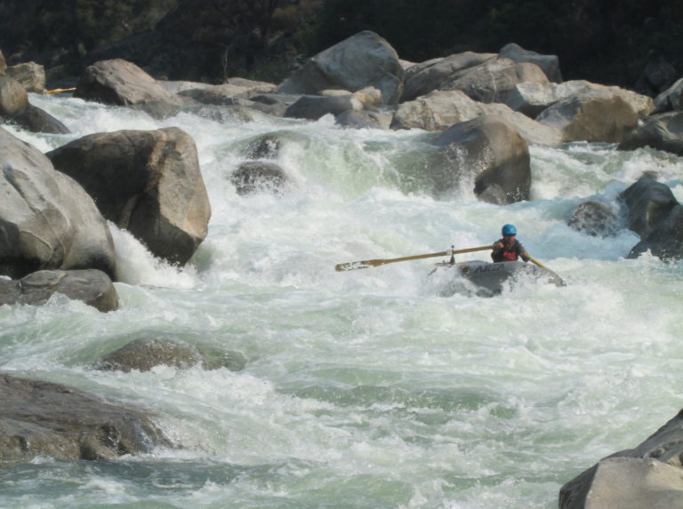 Raft in Lewis's Leap rapid on the Cherry Creek section of the Upper Tuolumne River