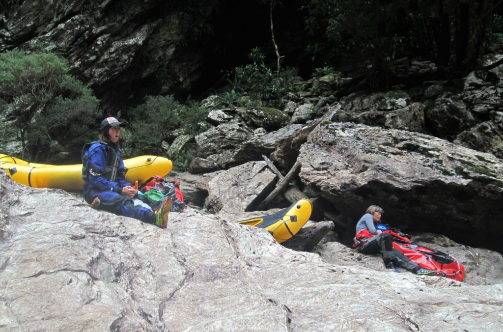 kayakers lunging with packrafts on rocks on a Franklin River packrafting and rafting trip