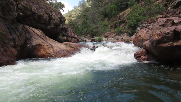 show size of rapid kayaker running in rocky gorge