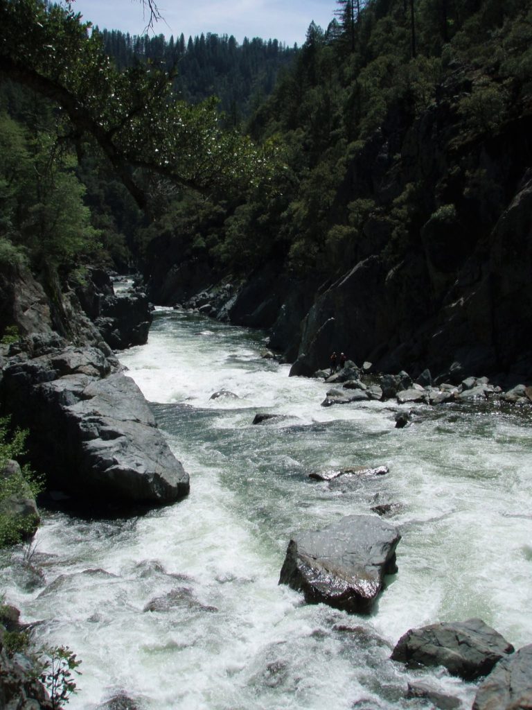 shows kayakers scouting the second half of Landslide rapid on the Middle Feather