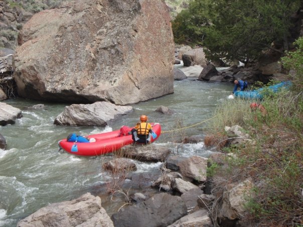 rafters lining raft from eddy at top of rapid