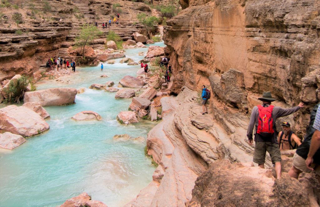 rafters crossing creek in river shoes