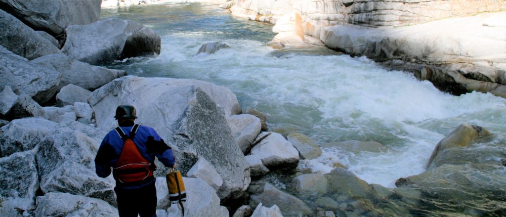 rafters walking with throw bag to scout rapid