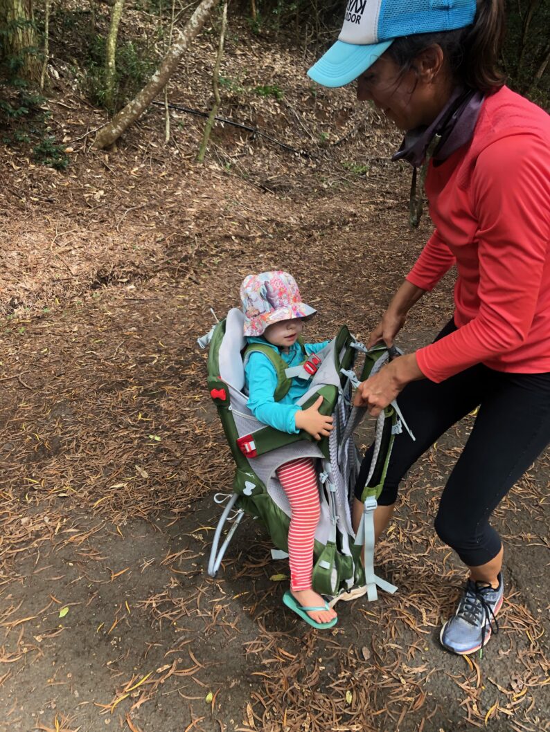 toddler in backpack carrier about to be picked up