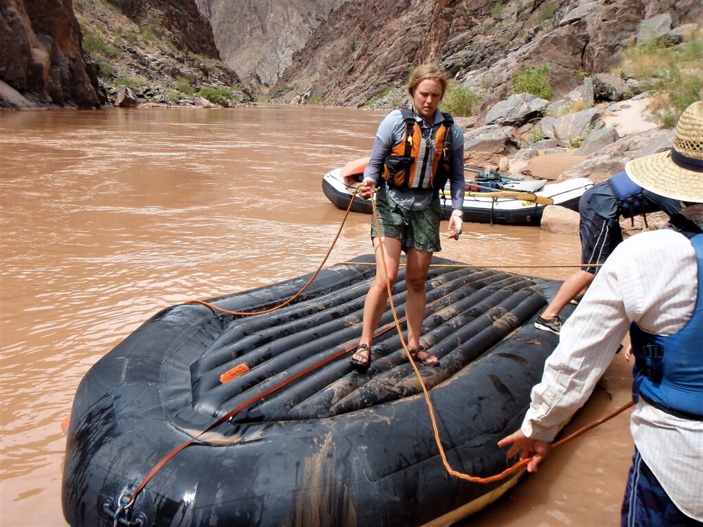 guide setting up throw bags to flip a raft