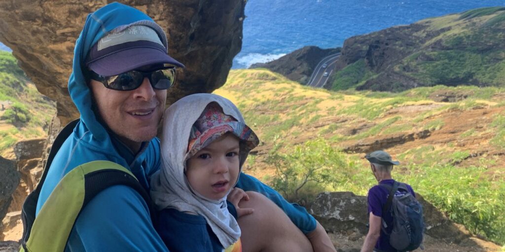 hiking above ocean wearing sun hoodies