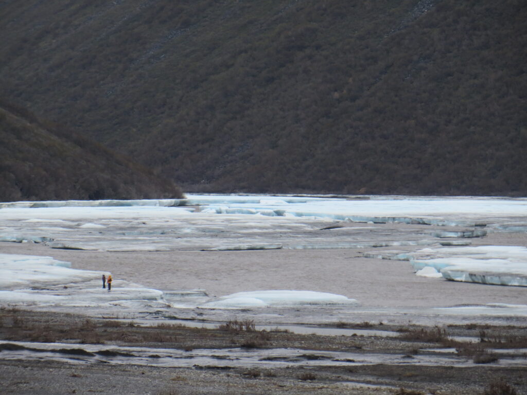 two rafters scouting route through the aufeis