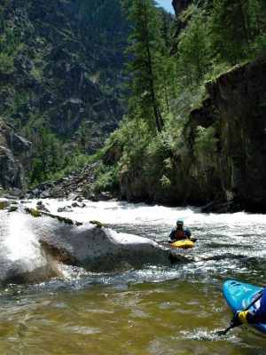 Kayakers in the third Drop of Fall Creek Rapid on the South Fork of the Salmon River